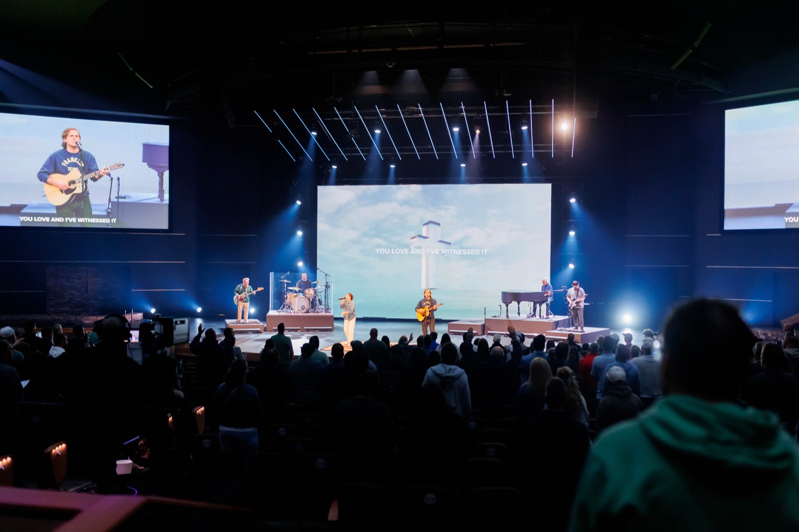Worship band on stage with the congregation standing