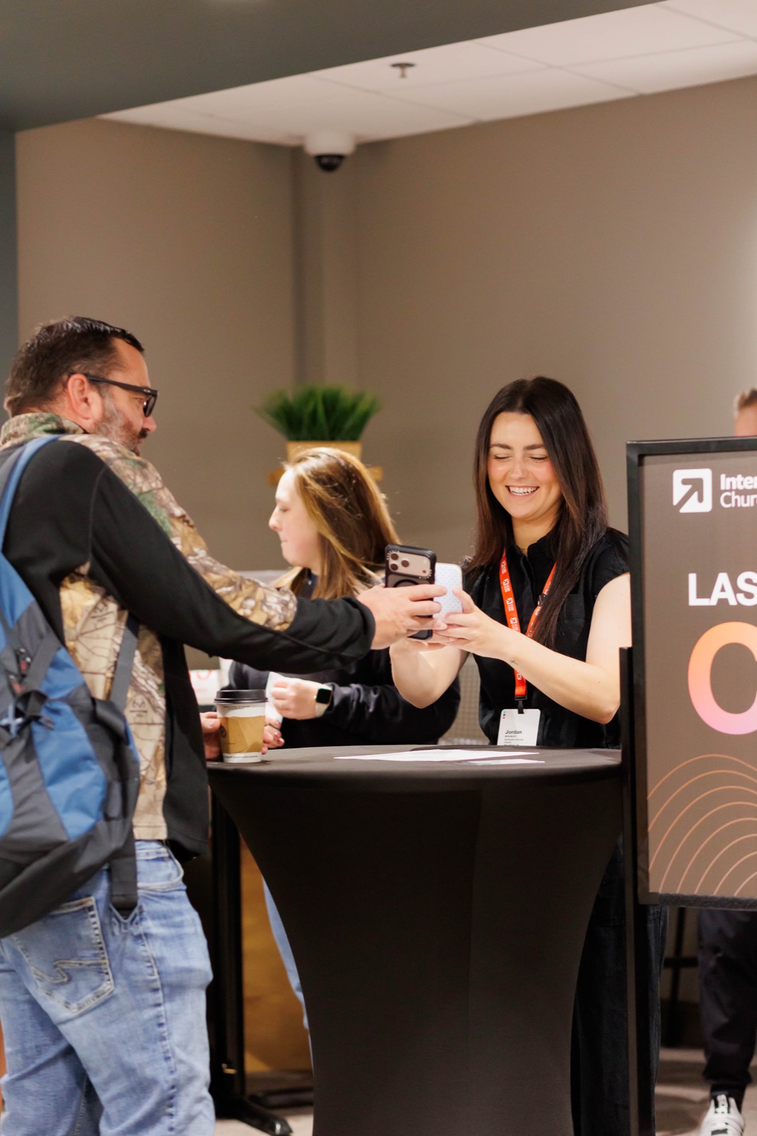 A guest checking in at the conference registration table
