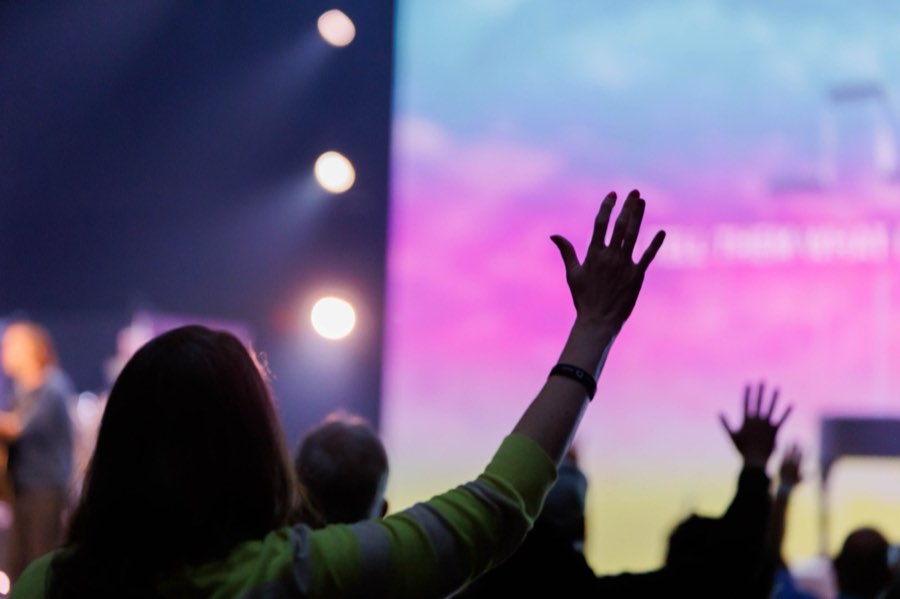 Attendee with a raised hand during worship