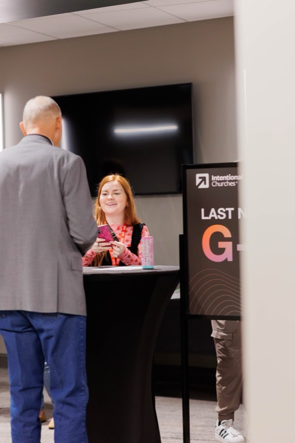 Attendee checking in at the registration table